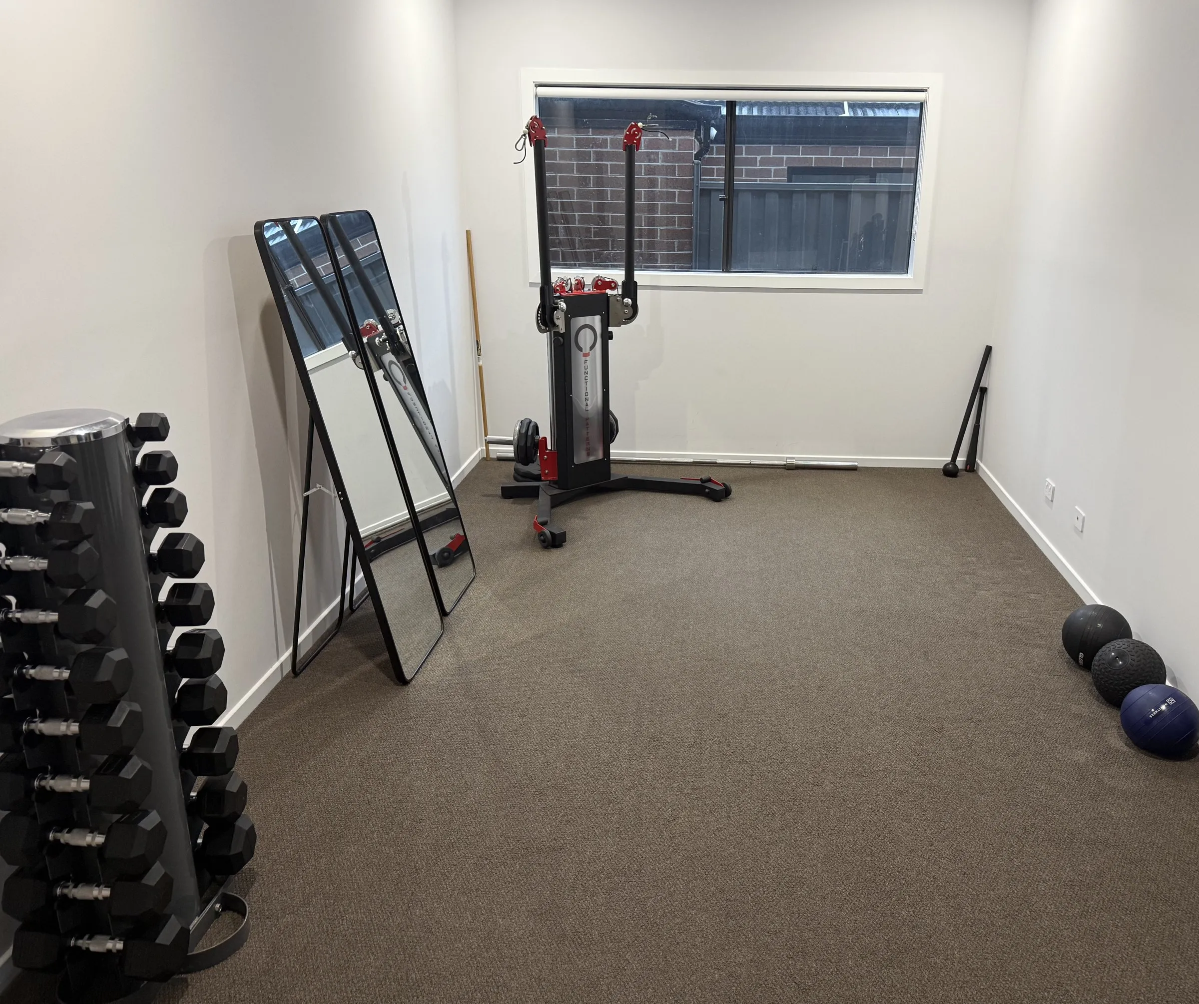 Filippo's private training studio in Werribee, with mirrors, a pulley system and an equipment rack